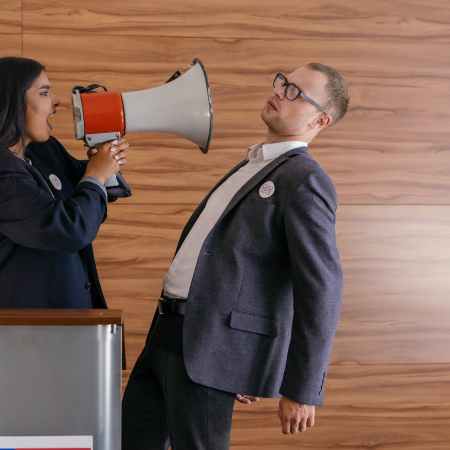 woman shouts on man using megaphone