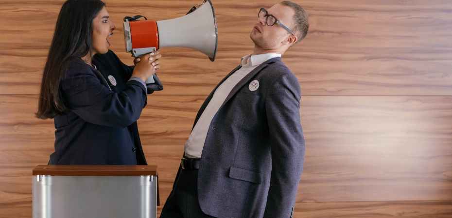 woman shouts on man using megaphone