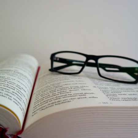 close up of eyeglasses on book